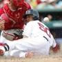 Boston Red Sox's Mookie Betts (50) slides into home against Philadelphia Phillies' catcher Cameron Rupp after hitting a solo home run in the bottom of the third inning during an exhibition spring training baseball game, Sunday, March 22, 2015, in Fort Myers, Fla. (AP Photo/Brynn Anderson)