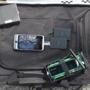 A black laptop case, a portable hard drive (top left), a cell phone and spare batteries (center), and a homemade remote control device (bottom right) were entered as evidence during the Marathon bombing trial.