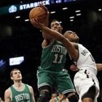 Boston Celtics guard Evan Turner (11) fouls Brooklyn Nets guard Jarrett Jack (0) during the first half of an NBA basketball game, Monday, March 23, 2015, in New York. (AP Photo/Mary Altaffer)