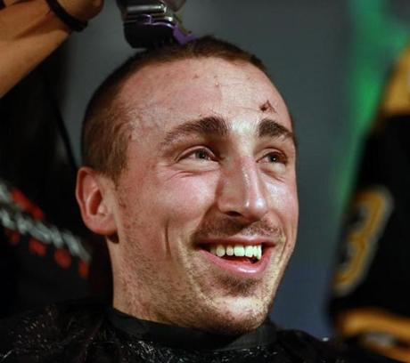 Brad Marchand smiled as his hair was cut during the 