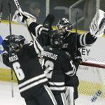 Providence's, from the left, Noel Acciari, Tom Parisi, Stefan Demopoulos, and goaltender Jon Gillies, celebrate after defeating Denver in the NCAA East Regional hockey tournament, Sunday, March 29, 2015, in Providence, R.I. (AP Photo/Steven Senne)