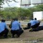 Kenyan police officers took cover outside the Garissa University College during an attack by gunmen in Garissa, Kenya.