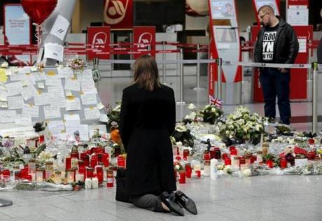 A woman kneeled in front of candles and flowers as she prayed for the victims of the Germanwings  crash at an airport in Duesseldorf, Germany.
