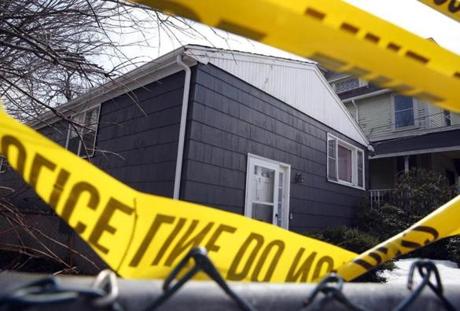 Police tape marked a home on Trull Street in Dorchester where two sisters were found dead Wednesday.
