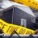Police tape marked a home on Trull Street in Dorchester where two sisters were found dead Wednesday.