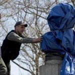 New York City Parks workers removed a covered molded bust of Edward Snowden at Fort Greene Park in Brooklyn. 