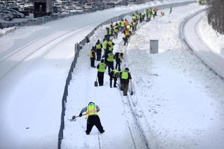 Quincy, MA - 02/17/15 - Crews shovel snow from MBTA Red Line tracks just outside the North Quincy T station Tuesday afternoon, February 17, 2015. Lane Turner/Globe Staff Section: METRO Reporter: typist Slug: 
