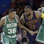 Boston Celtics? Marcus Smart (36) drives past Cleveland Cavaliers' LeBron James (23) as Celtics' Brandon Bass (30) blocks during the first quarter of an NBA basketball game Friday, April 10, 2015, in Cleveland. (AP Photo/Tony Dejak)