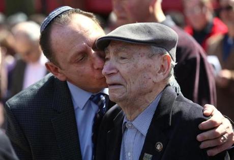 At an outdoor gathering Sunday, Mark Rogozinski leaned over to kiss his 91-year-old father, Abram Rogozinski, who is a survivor of seven camps. 
