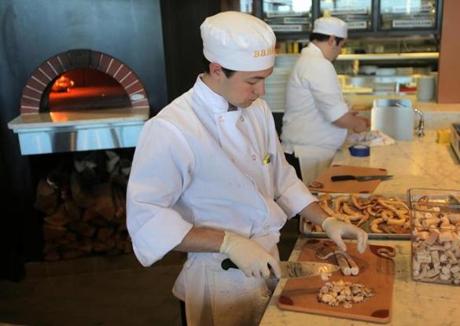 Boston, MA - 04/13/15 - Pizza cook Ryan Schaub works by the pizza oven in Mario Batali's new restaurant, Babbo Pizzeria, in the Seaport District. Lane Turner/Globe Staff Section: BIZ Reporter: taryn luna Slug: 15batali
