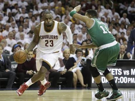 LeBron James drove past Evan Turner in the first game of their playoff series Sunday.
