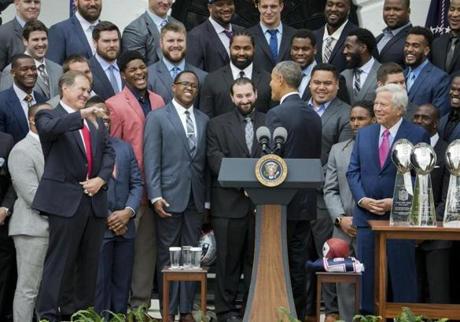 New England Patriots coach Bill Belichick, left, gives 'thumbs-down' to a joke President Barack Obama made during a ceremony welcoming the Super Bowl Champion New England Patriots, Thursday, April 23, 2015, on the South Lawn of the White House in Washington, to honor the team and their Super Bowl XLIX victory. On the right is Robert Kraft Chairman and CEO of the New England Partriots. (AP Photo/Pablo Martinez Monsivais)
