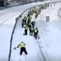 Crews shoveled snow from MBTA Red Line tracks. 