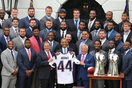 President Obama held up a Patriots jersey presented to him by the team.
