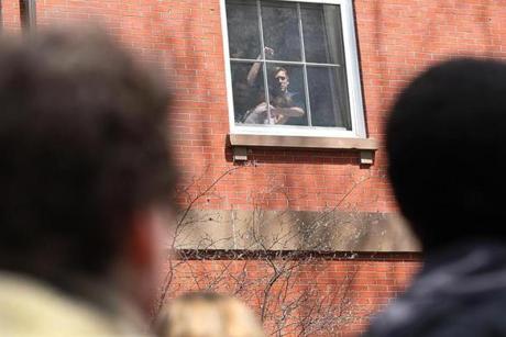 Tufts University students participating in a sit-in at Ballou Hall acknowledged the protesters outside. 
