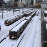 Snowed-in MBTA Red Line trains were idled in February. The report said the T should buy snow-clearing equipment. 