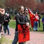 Participants of the May Day rally chanted, sang songs, and waved signs and flags before a planned march through the city.