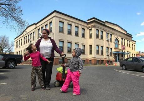 Temika Bennett and her three daughters outside a Holyoke preschool after the school day.
