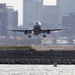 Logan Airport officials plan to curb energy consumption, cut emissions, and spend millions to protect runways from rising seas.