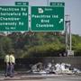 Police looked toward the wreckage of a plane crash on Interstate 285. 