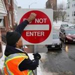 A city worker put up a new ?Do Not Enter? sign on East Eighth Street in February.