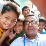 Rajesh Singh of Cigna taking a selfie with several children while on his CALL trip to Indonesia.