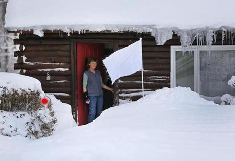 Homeowner Elaine Melanson stuck a white flag in the snow pile in front of her Norwell home in February.
