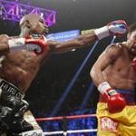 FILE - In this May 2, 2015 file photo, Floyd Mayweather Jr., left, hits Manny Pacquiao, from the Philippines, during their welterweight title fight in Las Vegas. The broadcast of fight was marred by technical snafus and got sucker punched by Internet streamers, exposing the industry?s vulnerabilities. (AP Photo/John Locher, File)