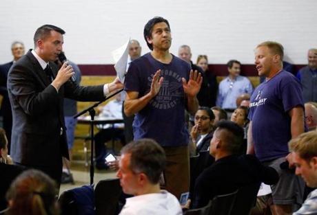 John FitzGerald of the Boston Redevelopment Authority (left), asked Robert Hanson of Dorchester (center), to stand down after he tried to ask a follow-up question at a meeting on Boston?s Olympic bid in Dorchester on Tuesday night. 
