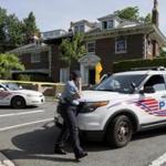 Washington police secured the vicinity around a fire-damaged home in northwest Washington, D.C., on Wednesday.