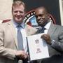 FILE - This is an Aug. 5, 2011, file photo showing NFL Comissioner Roger Goodell, left, and NFLPA Executive Director DeMaurice Smith shaking hands after signing their collective bargaining agreement at the Pro Football Hall of Fame in Canton, Ohio. Saying the NFL is 