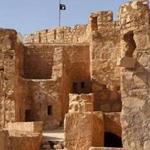 The Islamic State flag (center) was raised atop a castle in the historic town of Palmyra, Syria, on Friday, according to the photograph on the Islamic State website.
