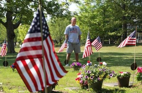 Jack Kane stopped by Brookdale Cemetery in Dedham on Sunday to visit the graves of his parents, John and Ruth, who both died this year. His father was a veteran of the Korean War. Families across the area are remembering those who lost their lives in combat.
