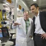 Udit Batra (right), chief executive of EMD Millipore, spoke with George Oulundsen while touring the firm?s bio-manufacturing sciences and training center.