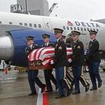 The remains of Army Corporal Elmer Richard arrived at Logan Airport Monday.  