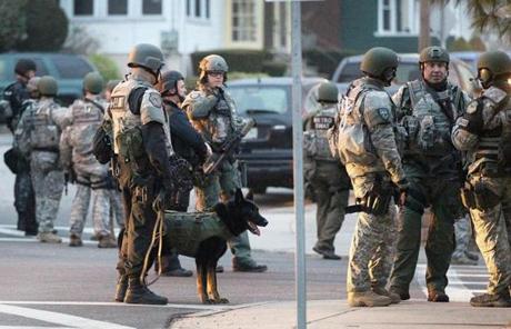 Police and canines prepared to patrol a section of Watertown.
