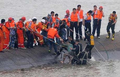 A survivor is rescued by divers from the Dongfangzhixing or ?Eastern Star? vessel which sank in the Yangtze river in Jianl
