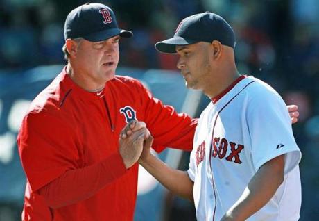 Manager John Farrell (left) may have something special on his hands in young lefty Eduardo Rodriguez. 
