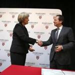 Harvard University president Drew Faust and John Paulson shook hands at Harvard on Wednesday. 