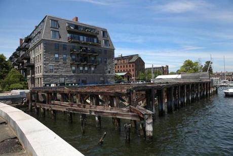 Lewis Wharf is now mostly a parking lot. But a proposal to redevelop the site in the North End (below) includes a hotel, residences, a park area, and a new home for the Boston Sailing Center.
