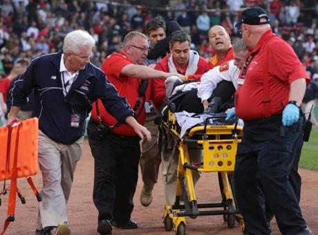BOSTON, MA - JUNE 5: A fan is attended to by medical staff after she was hit by a broken bat during a game between the Boston Red Sox and the Oakland Athletics in the second inning at Fenway Park on June 5, 2015 in Boston, Massachusetts. (Photo by /Getty Images)
