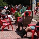 People enjoyed the chairs on City Hall Plaza in the Friday sun.