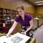 June 5, 2015 - Lauren Schott (cq) removes from a case a print she recovered from the Boston Public Library in the library's rare books room in Boston, Mass. Photo Credit: . Section: Metro. Reporter: andrew ryan. Slug: 06bpl(2).