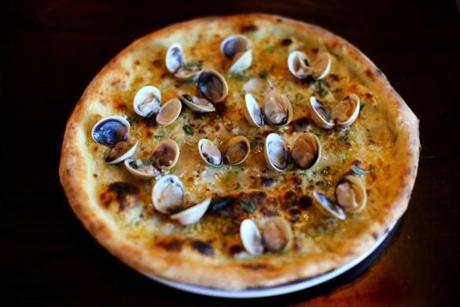 Vongole pizza with tiny clams in their shells, garlic, oregano, chile, cheese. 

