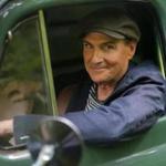 James Taylor, on the grounds of his Lenox home, in a 1950 Ford panel truck that had at one time seen use as an ambulance.