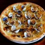 Vongole pizza with tiny clams in their shells, garlic, oregano, chile, cheese. 