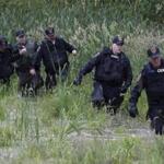 Law enforcement officers searched a field near Willsboro, N.Y., on Tuesday for two escapees from a maximum-security prison.