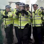 Police officers raised their batons at the gates of Downing Street during a protest in May.