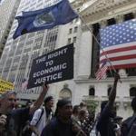 Occupy Wall Street protesters walked past the New York Stock Exchange.