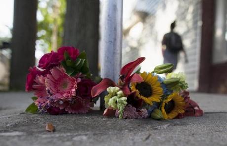 Flowers for the victims were laid near a police barricade.
